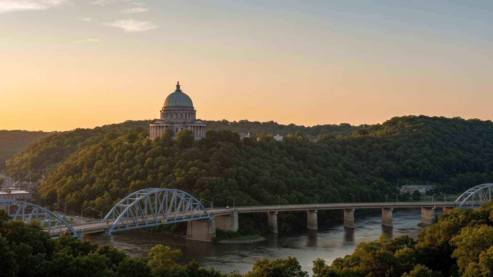 Editorial photograph of the Youngstown, Ohio skyline at golden hour with the Mahoning Valley industrial heritage visible in the background, evoking the steel city geography of northeast Ohio.