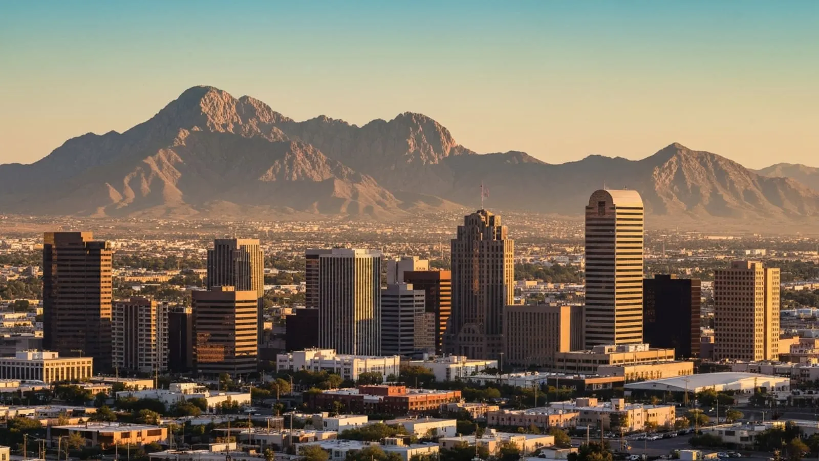 El Paso downtown skyline at golden hour with the Franklin Mountains rising behind the city and the border landscape visible