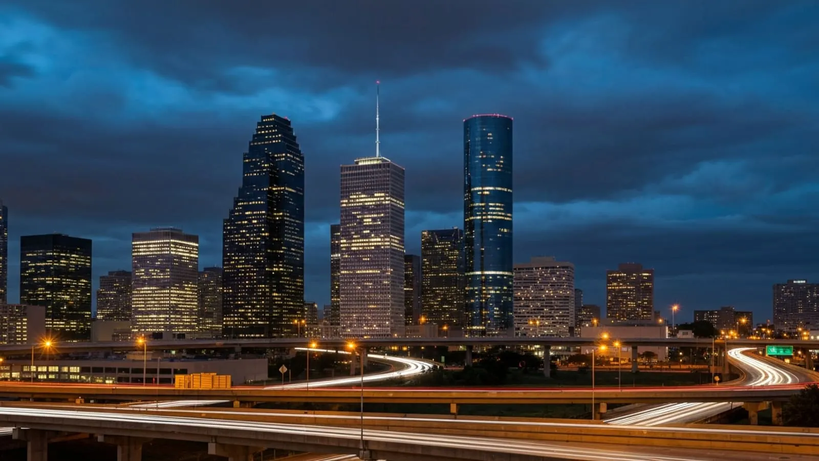Houston downtown skyline at twilight with the JPMorgan Chase Tower and the Wells Fargo Plaza illuminated
