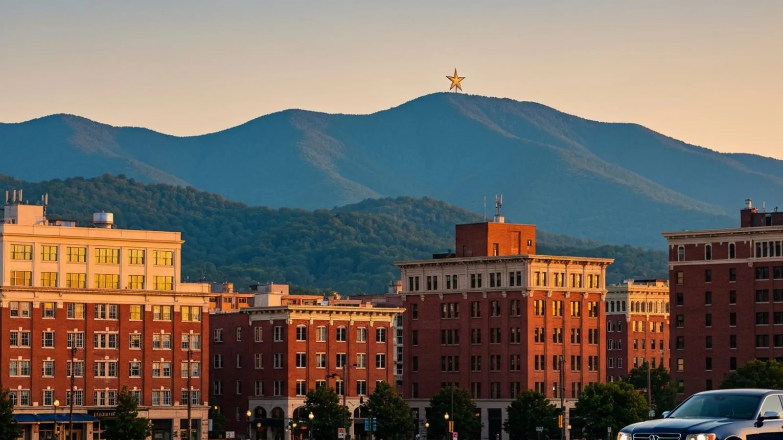 Editorial photograph of downtown Roanoke Virginia at golden hour with the Blue Ridge Mountains in the background and the iconic Mill Mountain Star illuminated on the ridge.